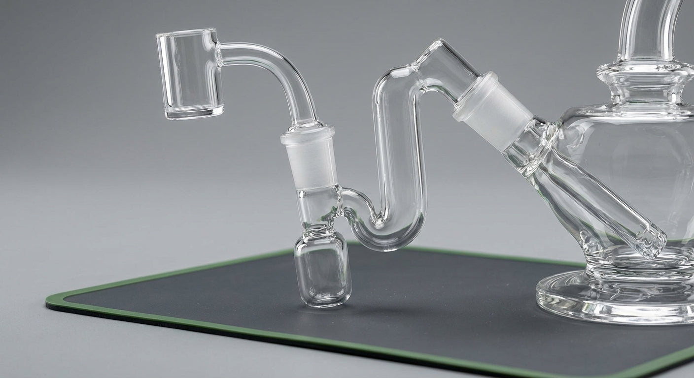 Close-up photo of a reclaim catcher installed between a quartz banger and a glass rig,  joint angles and the collecti...