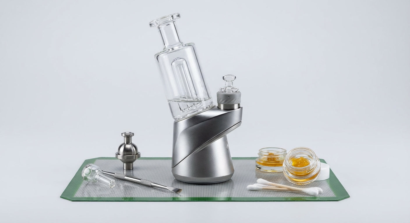 Close-up of a modern electric dab rig on a silicone dab mat with tools and concentrates around it