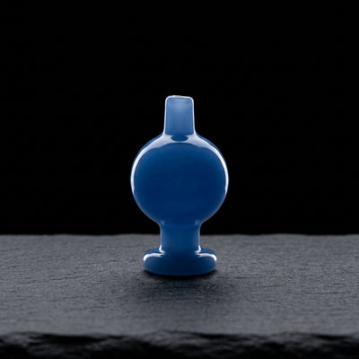 1.5″ BLUE CARB CAP on dark slate surface - Oil Slick Pad
