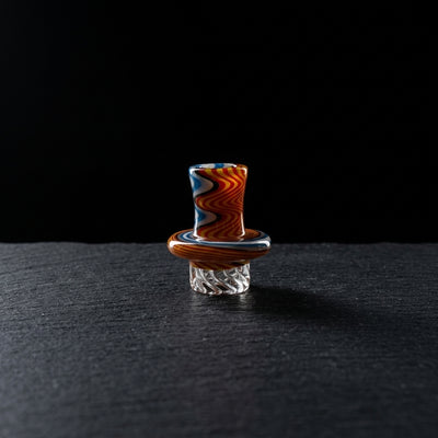1.5" Wigwag Top Hat Spinner Cap on dark slate surface - Oil Slick Pad