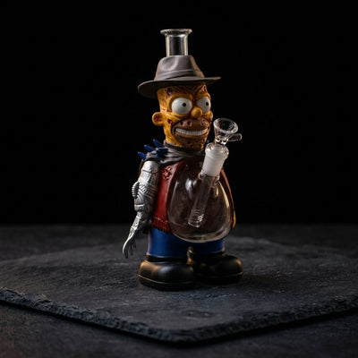 10.9'' Steel Claw Yellow Man Water Pipe on dark slate surface - Oil Slick Pad