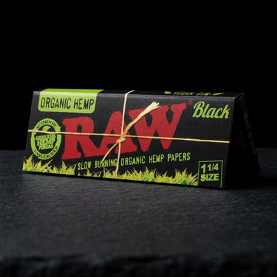 RAW Black Organic Hemp 1 ¼ Rolling Papers 24bx — Oil Slick editorial product photo
