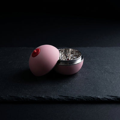 2.5" Boobies Grinder - 1 on dark slate surface - Oil Slick Pad