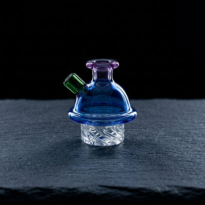 2.5" Color Beaker Spinner Carb Cap on dark slate surface - Oil Slick Pad