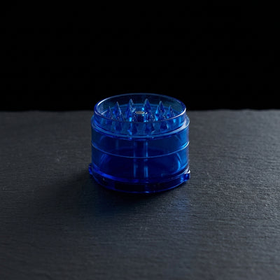 2.5" Plastic Magnetic Grinder on dark slate surface - Oil Slick Pad