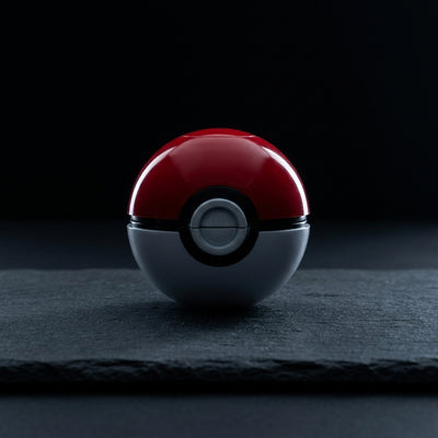 2.5" Pokeball Grinder on dark slate surface - Oil Slick Pad