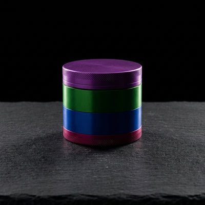 2.5" Toothless Grinder on dark slate surface - Oil Slick Pad