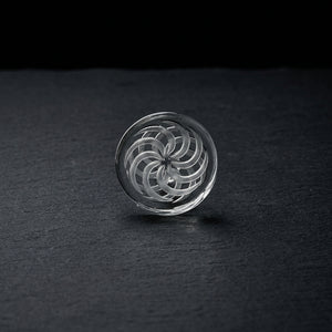 2″ Carved Spinner Disc Carb Cap on dark slate surface - Oil Slick Pad