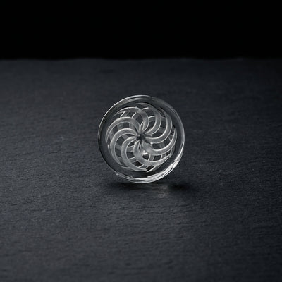2″ Carved Spinner Disc Carb Cap on dark slate surface - Oil Slick Pad