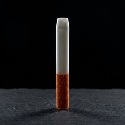2'' Ceramic Cigarette Chillum - 1 on dark slate surface - Oil Slick Pad