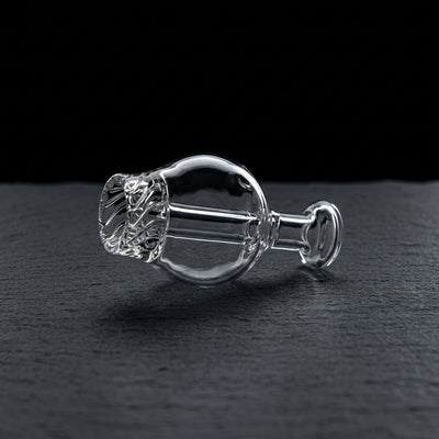 2″ Clear Vortex Carb Cap on dark slate surface - Oil Slick Pad