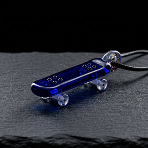 2″ Skateboard Pendant on dark slate surface - Oil Slick Pad
