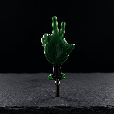 3.5″ 10mm Sculpted Hand Glass Nectar Straw on dark slate surface - Oil Slick Pad