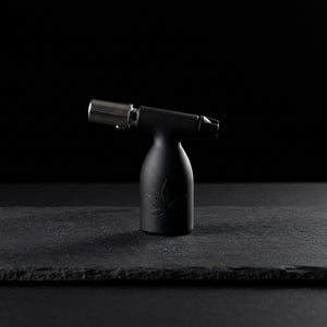 3.5″ Aleaf Mini Turbo Flame Blow Torch on dark slate surface - Oil Slick Pad