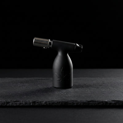3.5″ Aleaf Mini Turbo Flame Blow Torch on dark slate surface - Oil Slick Pad