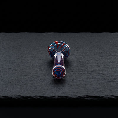 3.5" Color Spiral Glass Hand Pipe on dark slate surface - Oil Slick Pad