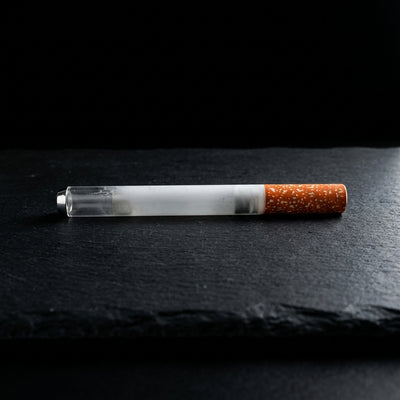 3'' Metal Cigarette Chillum - 1 on dark slate surface - Oil Slick Pad