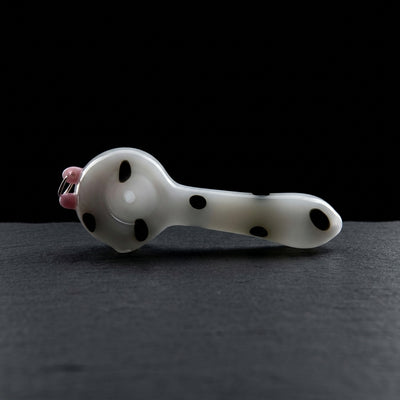 4" Pierced Udder Cow Hand Pipe on dark slate surface - Oil Slick Pad