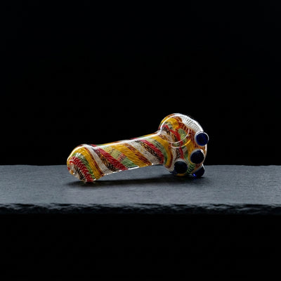 4.5″ Color Spiral Glass Hand Pipe on dark slate surface - Oil Slick Pad