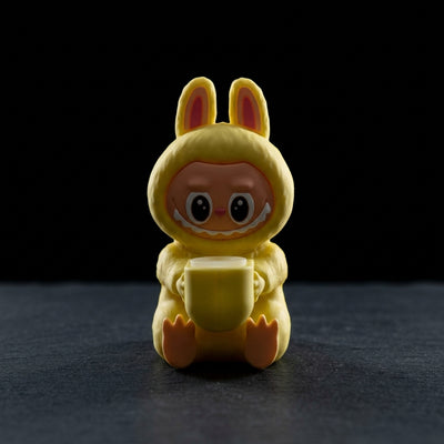 5.5″ Silicone Sitting Labubong on dark slate surface - Oil Slick Pad