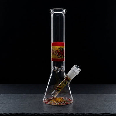 10'' Wigwag Decal Beaker w/ Wigwag Downstem on dark slate surface - Oil Slick Pad