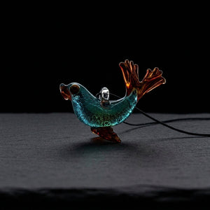 2.25" Peaselburg Dichro Seal Pendant on dark slate surface - Oil Slick Pad