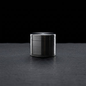 2" Classic Zinc Grinder - 1 on dark slate surface - Oil Slick Pad