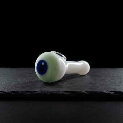 Eye hand pipe on dark slate surface - Oil Slick Pad