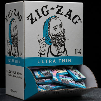 Zig Zag Promo Display (48 Pack) - 1 ¼ Ultra Thin Papers on dark slate surface - Oil Slick Pad