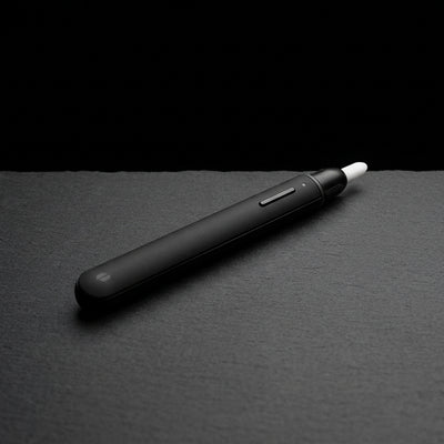 Puffco Heated Loading Tool V2 - Onyx on dark slate surface - Oil Slick Pad