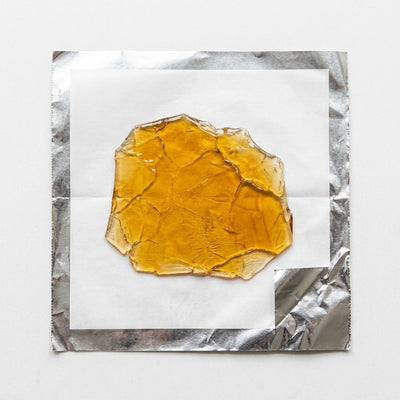 Oil Slick Wrap - Translucent amber shatter ready to fold on foil-backed parchment sheet