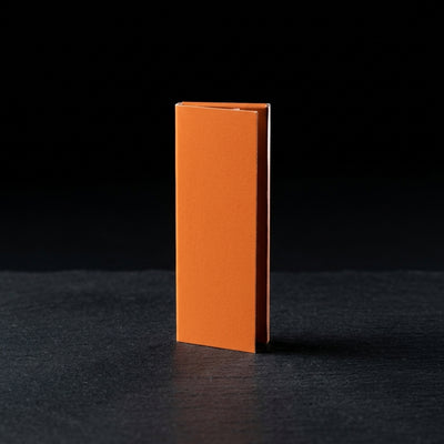 Zig Zag 1 ¼ French Orange Rolling Papers on dark slate surface - Oil Slick Pad