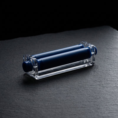 Zig Zag Cigarette Roller 70mm Carton on dark slate surface - Oil Slick Pad