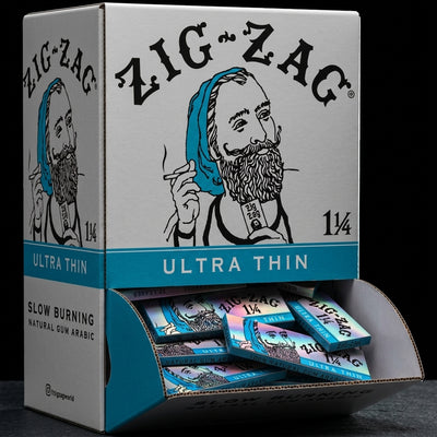 Zig Zag Promo Display (48 Pack) - 1 ¼ Ultra Thin Papers on dark slate surface - Oil Slick Pad